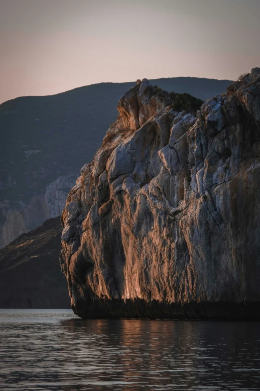 an island made of rocks on the water