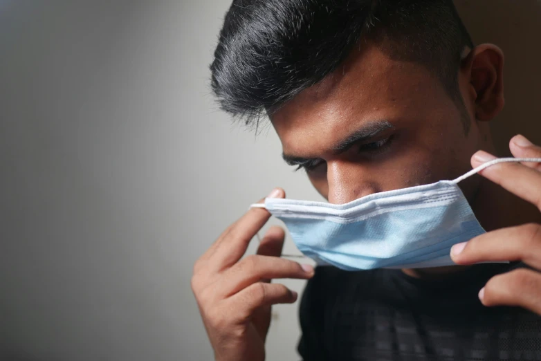 a young man with a mask covering his face