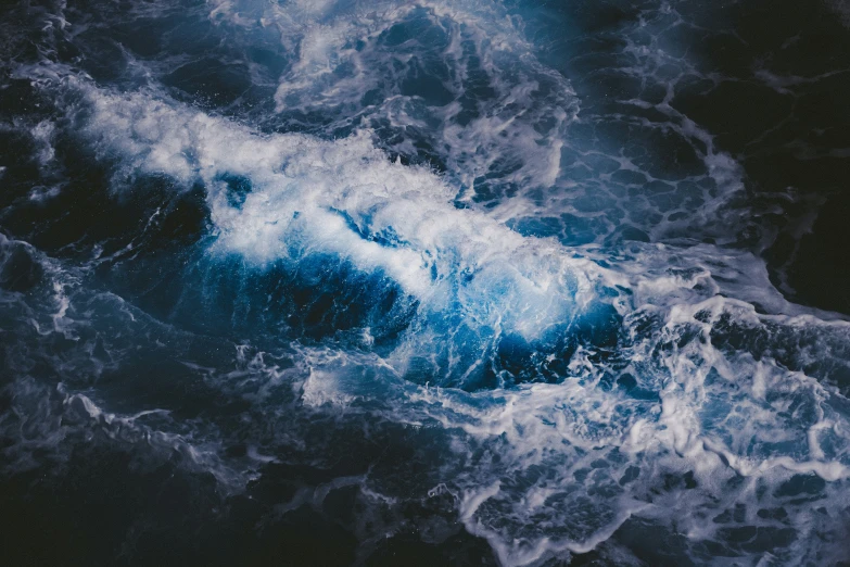 some dark blue water waves are close together