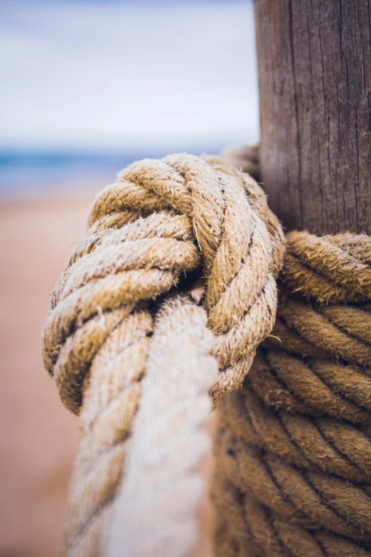 ropes that are tied together with the sand in the background