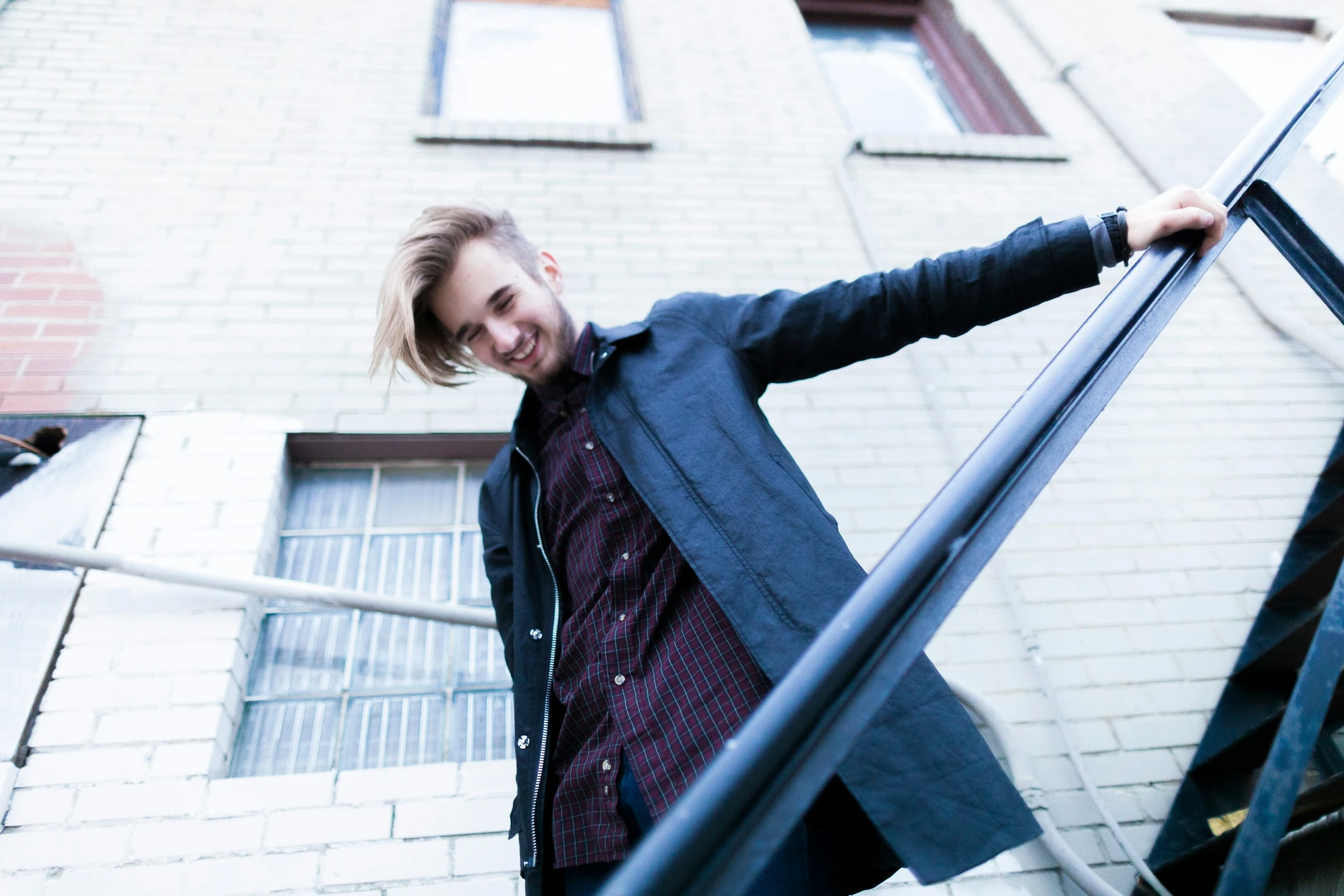 a man wearing a suit standing next to an urban building