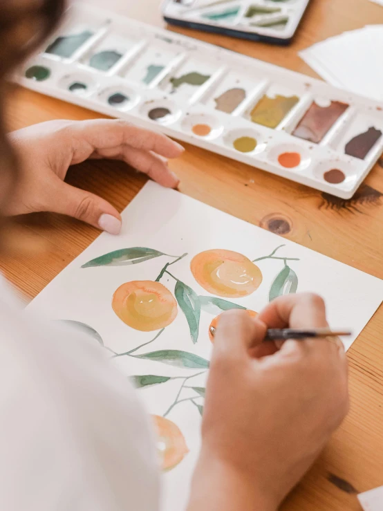 the person is painting some food on the table