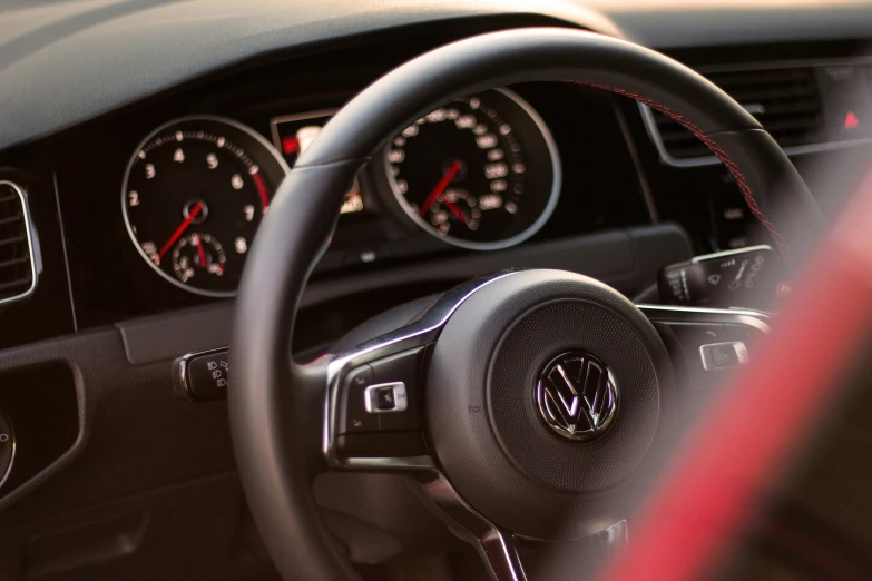 the dashboard of a volkswagen with red light indicating the time