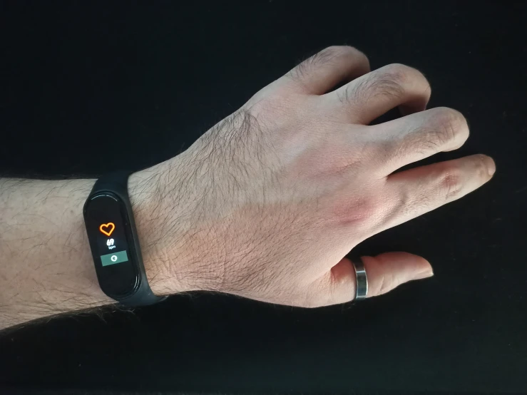 a mans hand with a smart watch in it