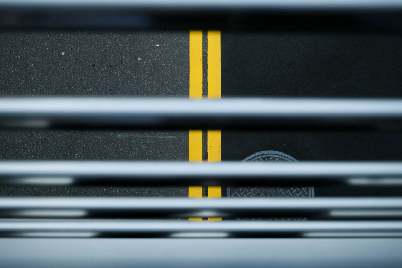 an overhead view of the yellow line of a street