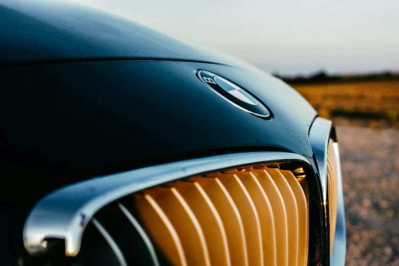 the side of a classic black and yellow car