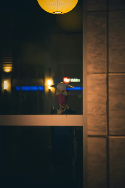 a lamp sitting above a window on the side of a wall