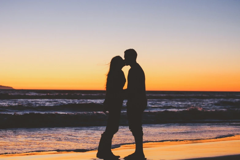 a couple of people that are standing near the water