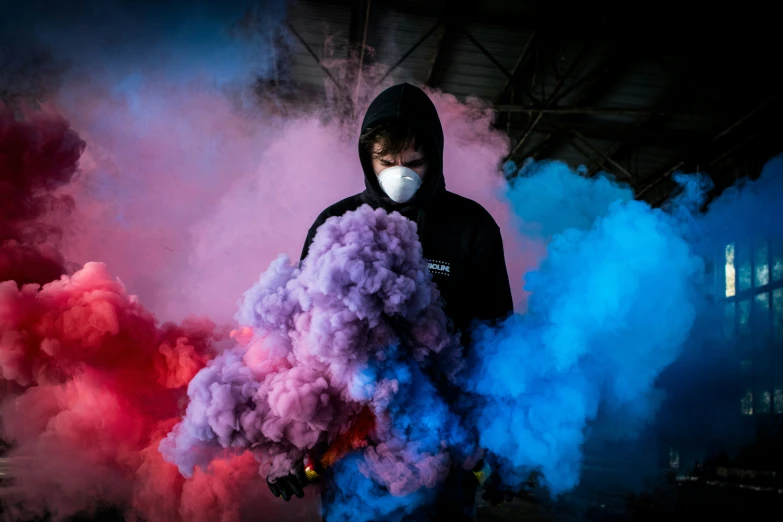 a man is standing by a bunch of smoke