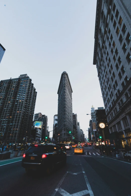 a car in a street with some tall buildings