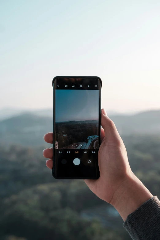 a person holding an iphone taking a picture