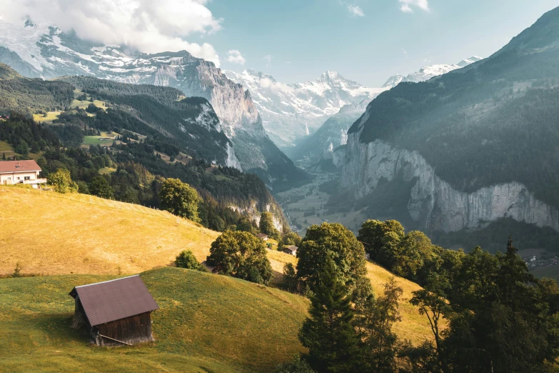 the view from a hill in the valley with trees and a building