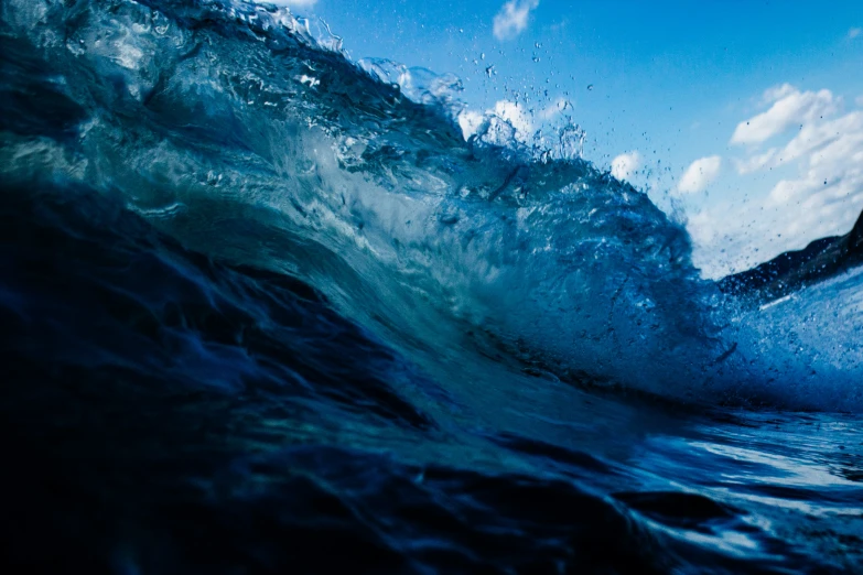 water is seen being splashed against a dark blue background