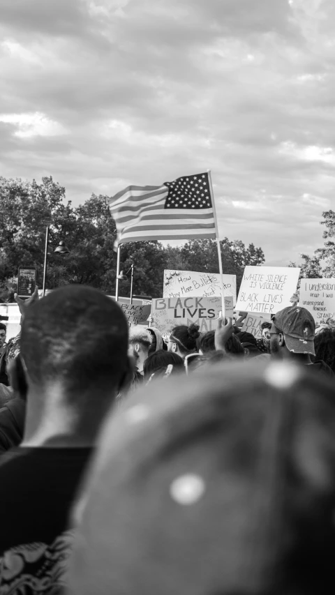 a large group of people holding signs at a demonstration