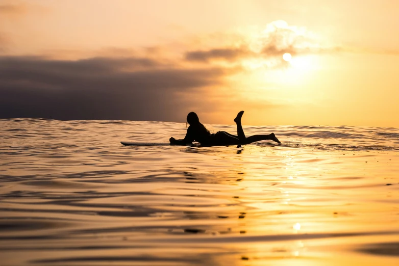 a person is on a surfboard out in the ocean