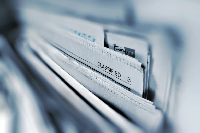 a stack of newspaper sitting on top of each other