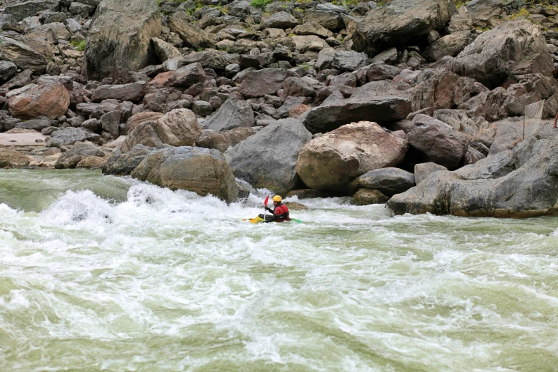 a person is paddling along on some waves