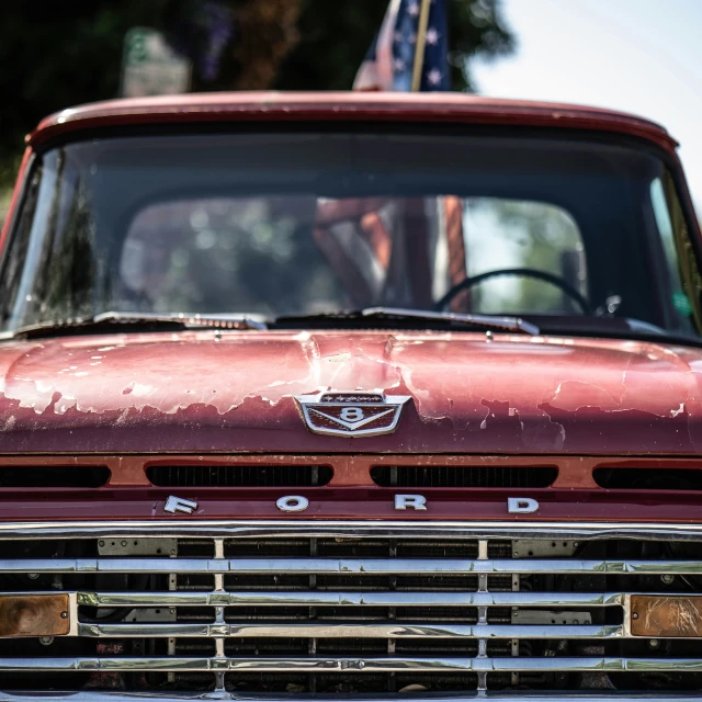 a red truck parked next to another old one