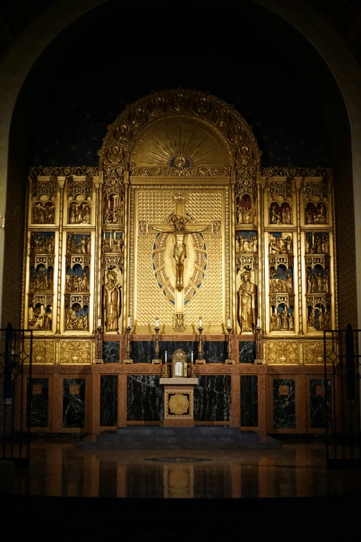 an elaborately decorated altar with a priest standing