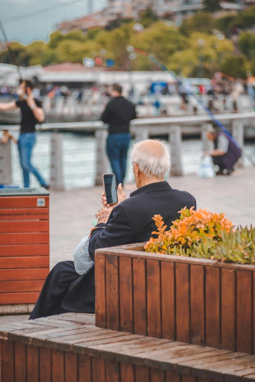 an elderly man is taking a po on a boardwalk