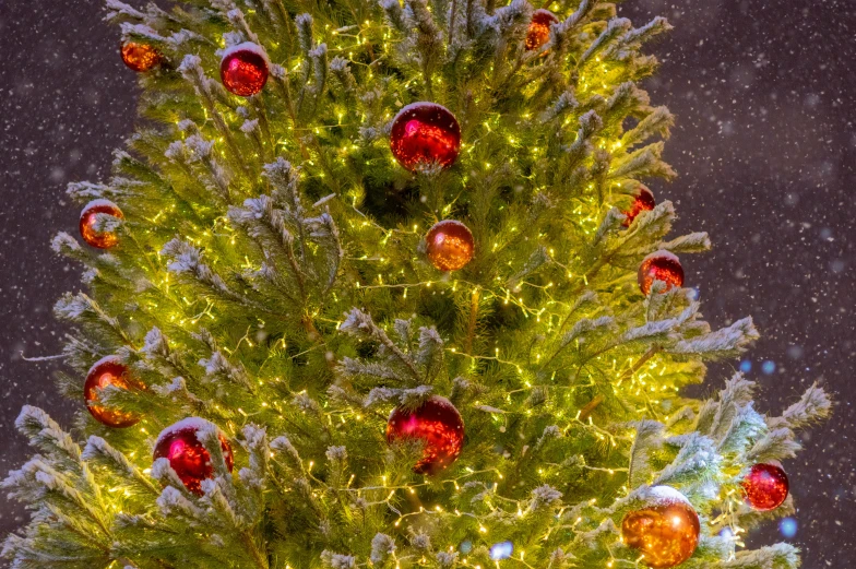 christmas tree decorated with bright ornaments and snow