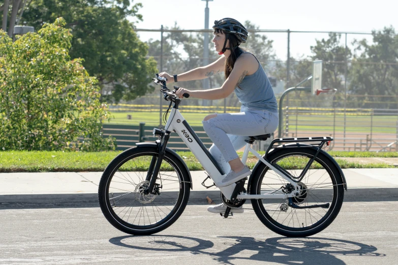 a person riding a white bike with a helmet on