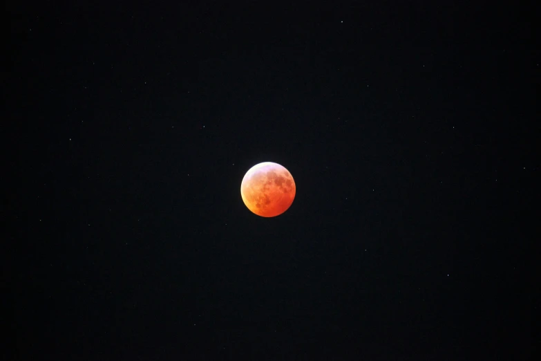 a partial eclipse seen through a dark sky with no clouds