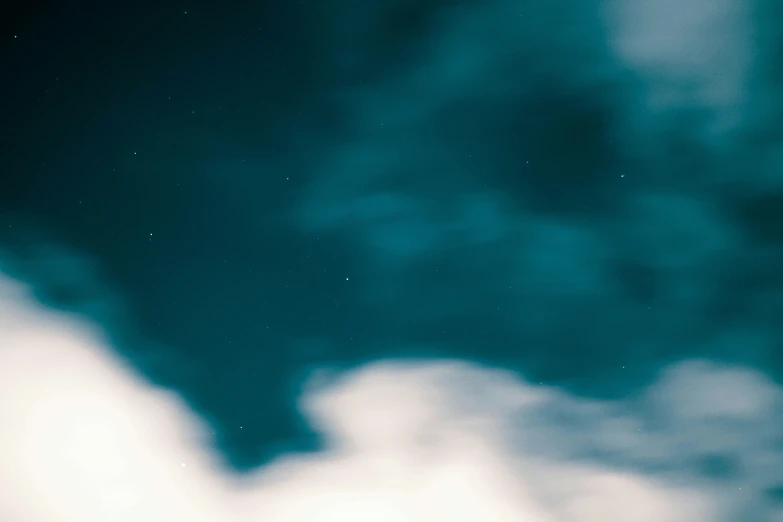 two kites flying in the sky at night