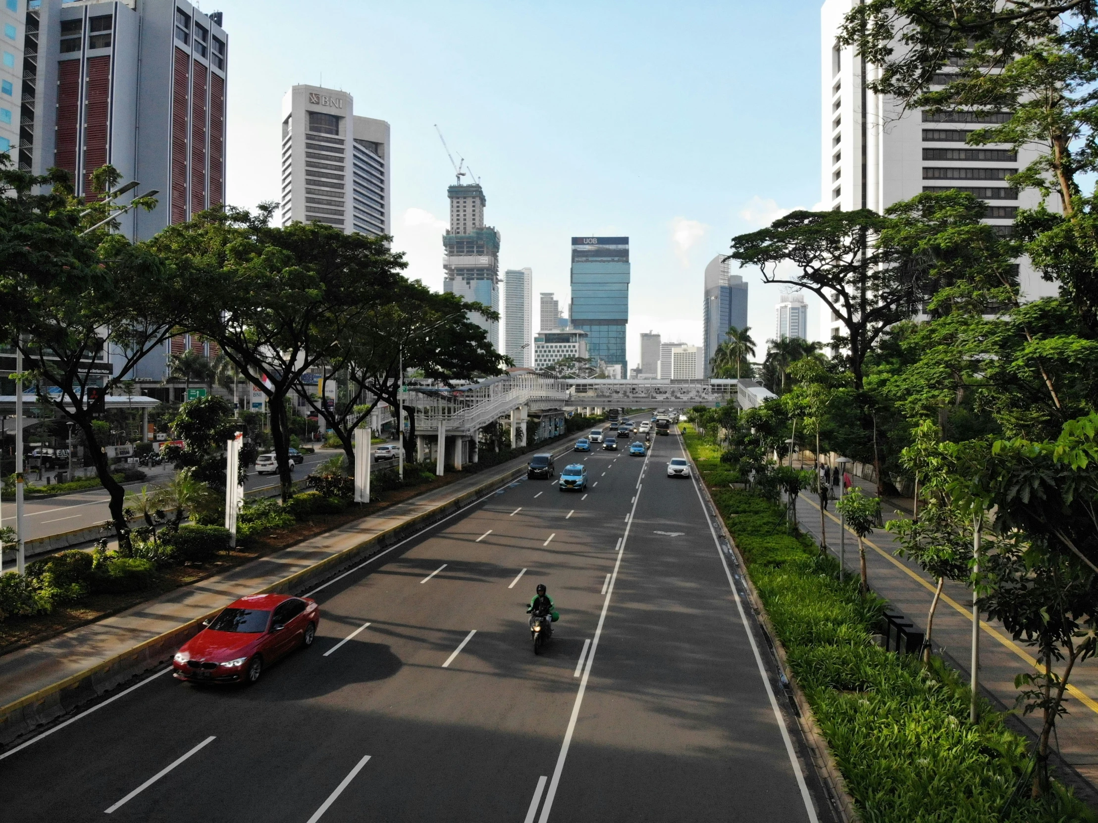 cars are driving along the city street in the daytime