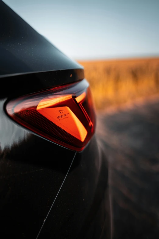 the tail light on a modern vehicle is reflecting the landscape