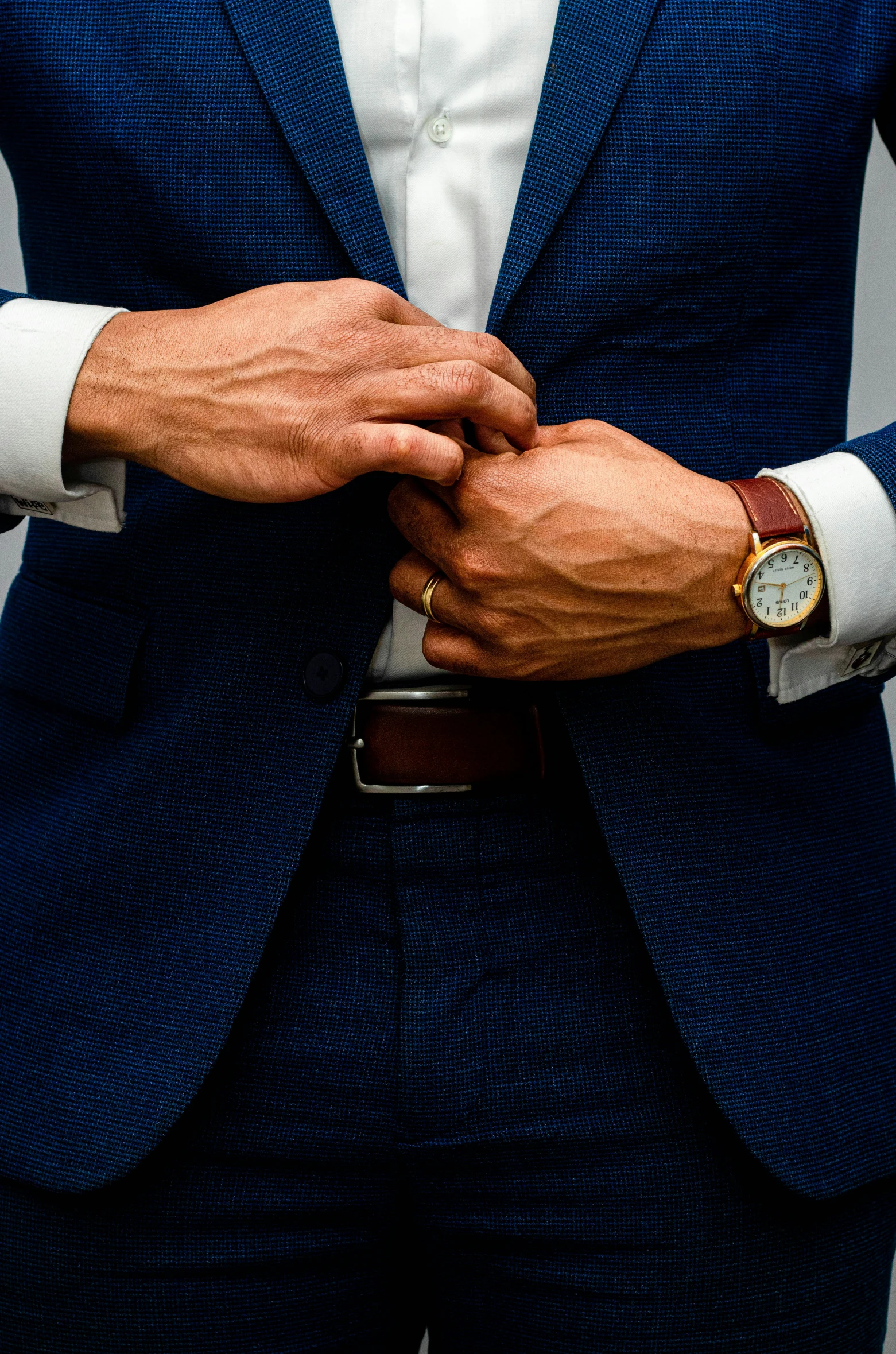 a man wearing a blue suit with white shirt