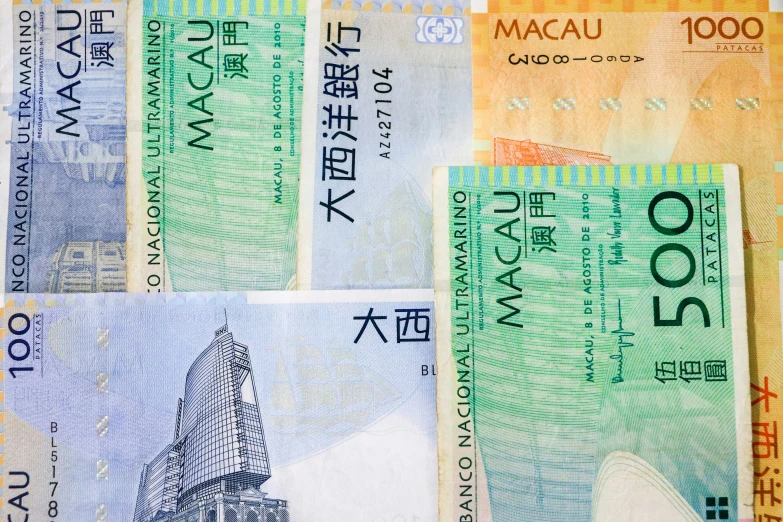 an arrangement of four colorful asian bank notes