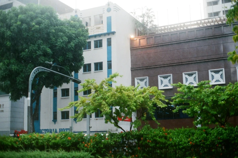 the outside of a el building and some greenery