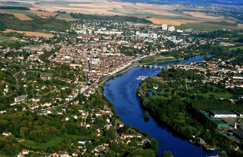 a view of a city, water and land near a river