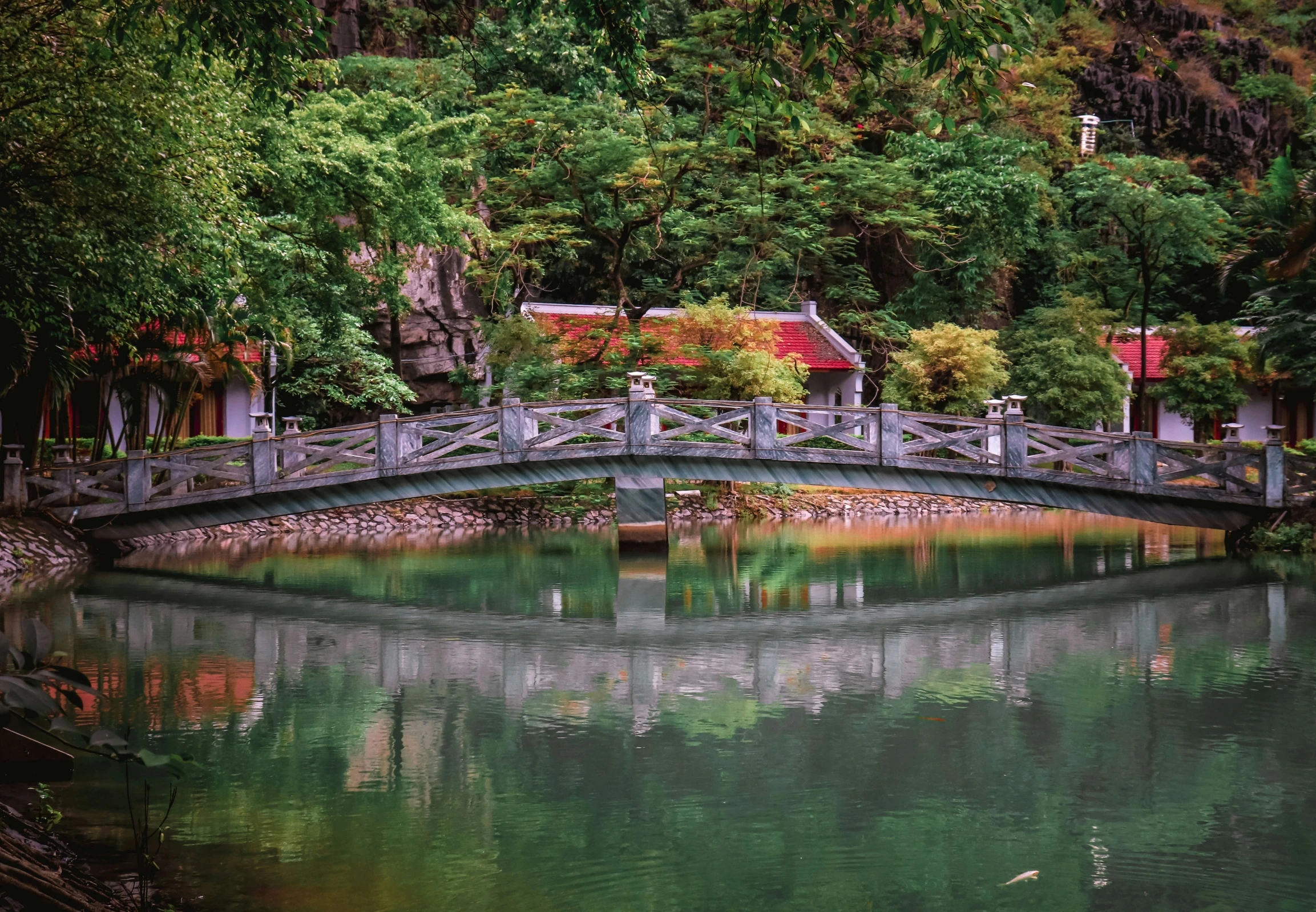 a bridge over water with people walking on it