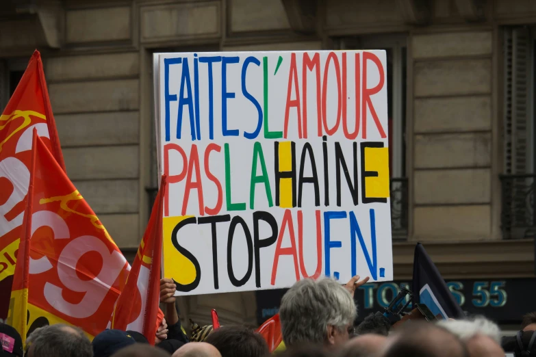 there is a protest in the street and a sign