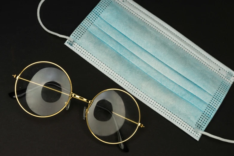 a mask, glasses and a face covering on a table