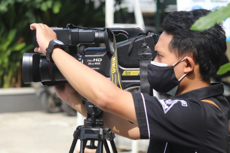 a person in black shirt holding up camera equipment