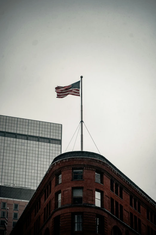 a flag is flying on the top of an old building