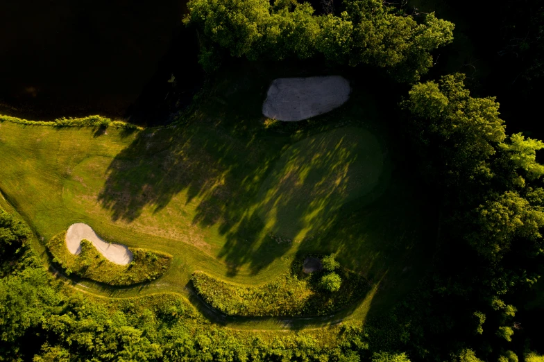 an aerial po of a golf course and trees