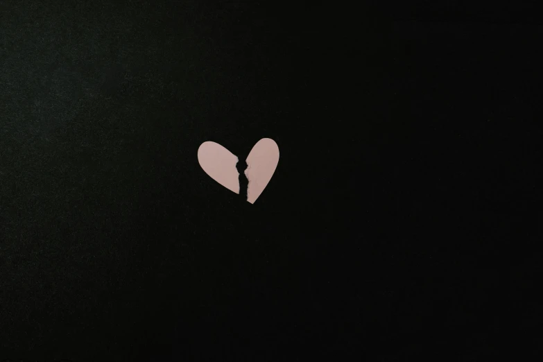 the broken heart is on a black surface