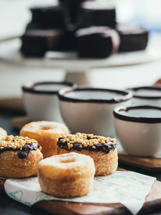 donuts and cups sit on a table