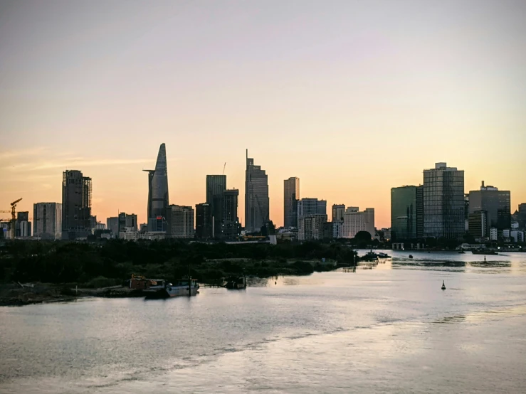 the city skyline is visible from across the water