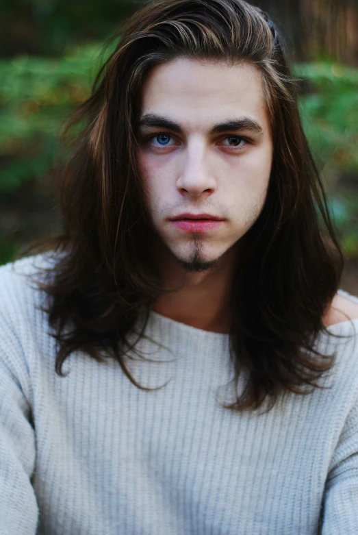 a young man with long hair and bangs