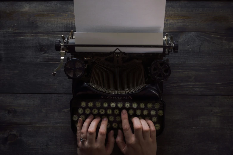 a person typing on an old typewriter