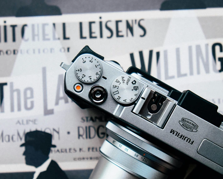 a silver analog camera is on display