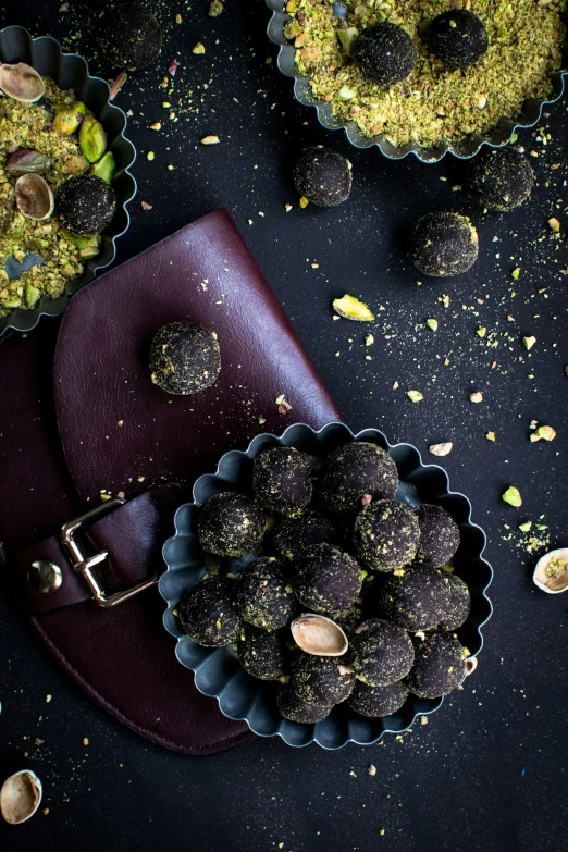 a chocolate covered dessert with nuts and green things