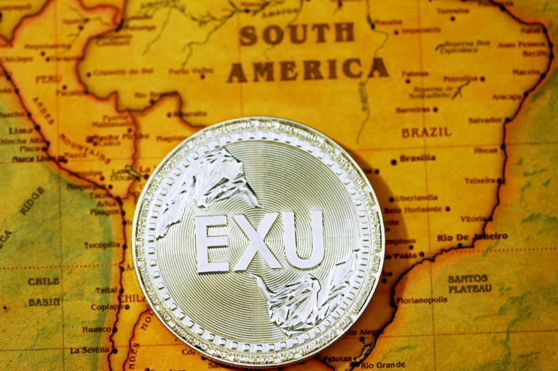 a coin sitting on top of the map of the world