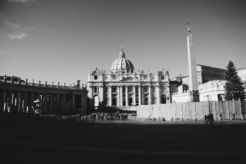 the side view of a large building with statues of people