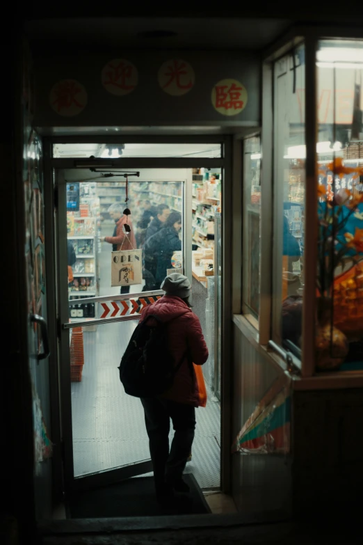 a man walks in a shop doorway